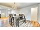 Dining room with a large table, bench seating, modern chandelier, and stylish flooring at 1540 Neely Store Rd, Rock Hill, SC 29730