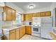 Kitchen with wood cabinets, white appliances, and lots of natural light at 1540 Neely Store Rd, Rock Hill, SC 29730