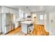 Modern kitchen with stainless steel appliances, white cabinets, an island with seating, and luxury vinyl plank flooring at 1540 Neely Store Rd, Rock Hill, SC 29730