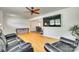 Open-concept living area with light hardwood floors, an entertainment center, and comfortable leather seating at 1540 Neely Store Rd, Rock Hill, SC 29730