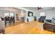Bright, open living area with hardwood floors, a ceiling fan, and an open layout flowing into the dining area and kitchen at 1540 Neely Store Rd, Rock Hill, SC 29730