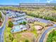 Aerial view showcasing community amenities, including tennis courts, a pool, and green spaces at 17231 Rider Wood Ln, Charlotte, NC 28278