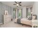 Comfortable bedroom featuring a bed with soft tones, striped wall decor, and plenty of natural light from the windows at 17231 Rider Wood Ln, Charlotte, NC 28278