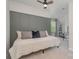 Comfortable bedroom with a decorative wall, neutral bedding, and ample natural light at 17231 Rider Wood Ln, Charlotte, NC 28278
