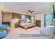 Beautiful primary bedroom featuring a neutral color palette, ceiling fan, and seating area at 17231 Rider Wood Ln, Charlotte, NC 28278