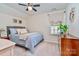 Cozy bedroom with comfortable queen bed, dresser, and bedside table near sunny window at 17231 Rider Wood Ln, Charlotte, NC 28278