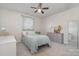 Comfortable bedroom with a ceiling fan, a large dresser, and natural light from the window at 17231 Rider Wood Ln, Charlotte, NC 28278