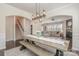 Open dining area with a long table and bench seats, steps to the staircase and a view of the living room at 17231 Rider Wood Ln, Charlotte, NC 28278