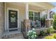 Inviting front porch with seating, decorative plants, and a stylish front door with wreath and welcome mat at 17231 Rider Wood Ln, Charlotte, NC 28278