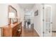 Inviting hallway with wood floors, decorative mirror, and console table leading to the living area at 17231 Rider Wood Ln, Charlotte, NC 28278