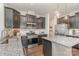 Modern kitchen featuring dark cabinets, granite countertops, stainless steel appliances, and an island at 17231 Rider Wood Ln, Charlotte, NC 28278