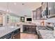 Open-concept kitchen with stainless steel appliances, granite countertops, and seamless flow into the living area at 17231 Rider Wood Ln, Charlotte, NC 28278