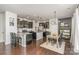 Open concept kitchen and dining area featuring black cabinetry, a kitchen island, and modern lighting at 17231 Rider Wood Ln, Charlotte, NC 28278