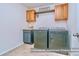 Modern laundry room features front loading washer and dryer with extra storage above at 17231 Rider Wood Ln, Charlotte, NC 28278