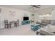 Comfortable living room featuring a gray sofa, ceiling fan, and a cozy seating area at 17231 Rider Wood Ln, Charlotte, NC 28278