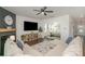 Comfortable living room with a fireplace, ceiling fan, and open access to the dining area at 17231 Rider Wood Ln, Charlotte, NC 28278