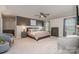Spacious main bedroom with a ceiling fan, large windows, and neutral decor at 17231 Rider Wood Ln, Charlotte, NC 28278