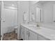 Bright bathroom with long vanity with modern hardware and a shower with patterned curtain at 179 Bezelle Ave # 34, York, SC 29745