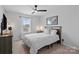 Well-lit bedroom with a ceiling fan, comfortable bed, and neutral decor for a calming atmosphere at 179 Bezelle Ave # 34, York, SC 29745