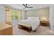 Bright bedroom boasts modern ceiling fan, large windows, designer curtains, and luxurious king bed at 179 Bezelle Ave # 34, York, SC 29745