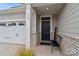 Inviting front entrance showcasing a black door, brick accents, and a cozy bench for added curb appeal at 179 Bezelle Ave # 34, York, SC 29745
