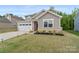 Attractive home featuring a two-car garage and a well-maintained front yard, complemented by brick accents at 179 Bezelle Ave # 34, York, SC 29745