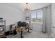 Contemporary home office featuring a modern light fixture, large window, and functional workspace at 179 Bezelle Ave # 34, York, SC 29745