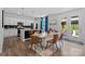 The open concept kitchen and dining area features modern appliances and access to an outdoor patio space at 179 Bezelle Ave # 34, York, SC 29745