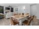 An open-concept living room showcases a fireplace, a ceiling fan, and a connected dining area at 179 Bezelle Ave # 34, York, SC 29745