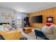 A comfy living room featuring vibrant yellow wall, sectional seating, arcade games, and large flat screen TV at 179 Bezelle Ave # 34, York, SC 29745