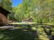 Fenced backyard with a pool house, swimming pool covered for the off-season, and lush greenery at 1855 7Th St, Salisbury, NC 28144