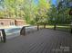 View from a wood deck looking onto the fenced in backyard and covered pool area at 1855 7Th St, Salisbury, NC 28144
