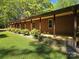 Long, covered porch showcasing wood siding, manicured hedges, and a lush lawn at 1855 7Th St, Salisbury, NC 28144