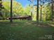 Charming single-story home nestled among mature trees and lush green lawn on a sunny day at 1855 7Th St, Salisbury, NC 28144
