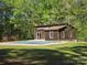 Pool house featuring sliding doors, windows, and a pool covered for the off-season at 1855 7Th St, Salisbury, NC 28144