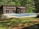 Close up of pool house exterior and pool covered for the off-season at 1855 7Th St, Salisbury, NC 28144