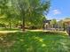 Spacious backyard with mature trees, a trampoline, and ample green space at 2002 Potomac Rd, Indian Trail, NC 28079