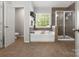 Well-lit bathroom featuring a separate shower and soaking tub at 2002 Potomac Rd, Indian Trail, NC 28079