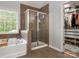 Well-lit bathroom featuring a separate shower and soaking tub at 2002 Potomac Rd, Indian Trail, NC 28079