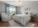 Bright bedroom features a ceiling fan, large window, and cozy decor at 2002 Potomac Rd, Indian Trail, NC 28079