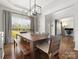 Well-lit dining room with wood floors, large windows, and an open view to office at 2002 Potomac Rd, Indian Trail, NC 28079