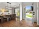 Elegant dining room features wood floors, modern chandelier, and natural light from front door view at 2002 Potomac Rd, Indian Trail, NC 28079