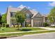 Beautiful two-story brick home with manicured lawn, mature landscaping, and attached garage at 2002 Potomac Rd, Indian Trail, NC 28079