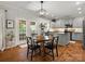 Bright eat-in kitchen featuring gray cabinetry, stainless appliances, hardwood floors, and backyard access at 2002 Potomac Rd, Indian Trail, NC 28079