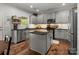 Well-appointed kitchen with gray cabinets, stainless appliances, granite counters and kitchen island at 2002 Potomac Rd, Indian Trail, NC 28079