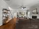 Bright living room with hardwood floors, a fireplace, and open access to the staircase at 2002 Potomac Rd, Indian Trail, NC 28079