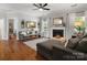 Inviting living room with fireplace, ceiling fan, hardwood floors, and comfortable seating at 2002 Potomac Rd, Indian Trail, NC 28079