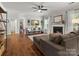 Spacious living room featuring hardwood floors, a fireplace, and abundant natural light at 2002 Potomac Rd, Indian Trail, NC 28079