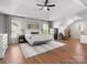 Spacious main bedroom featuring a trey ceiling, ceiling fan, and decorative rug on wood floors at 2002 Potomac Rd, Indian Trail, NC 28079
