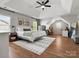 Spacious main bedroom featuring a trey ceiling, ceiling fan, and decorative rug on wood floors at 2002 Potomac Rd, Indian Trail, NC 28079